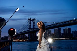Model posing in front of the bright, lit by a Rotolight Neo II, one of the best video lights