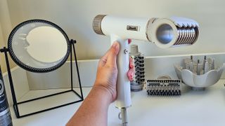 SharkSpeedStyle hairdryer being held in front of mirror with RapidGloss Finisher attachment connected