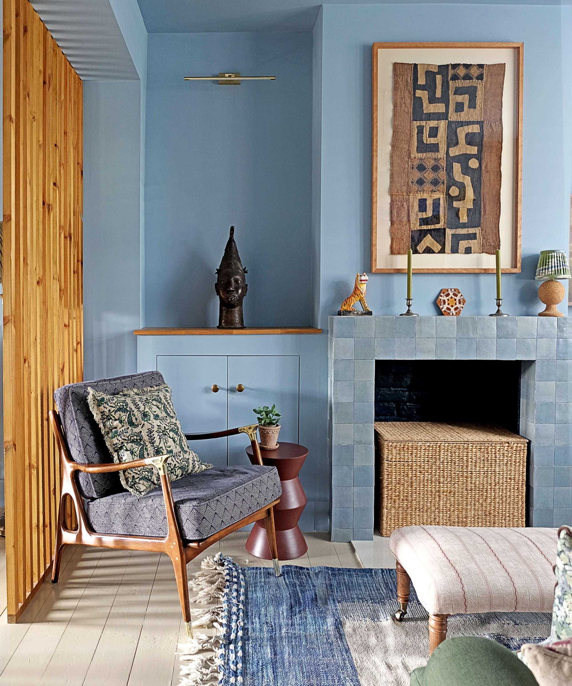 blue living room with tiled blue fireplace and mid century arm chair