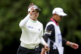 Miyu Yamashita taps her cap as she walks off the green at the Women's PGA Championship