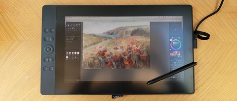 Ugee 16 review; photos of a person painting using a drawing tablet display