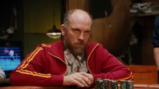 John Malkovich as Teddy KGB, wearing a red warm up jacket in Rounders