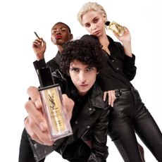Three models holding various YSL Beauty products with white background