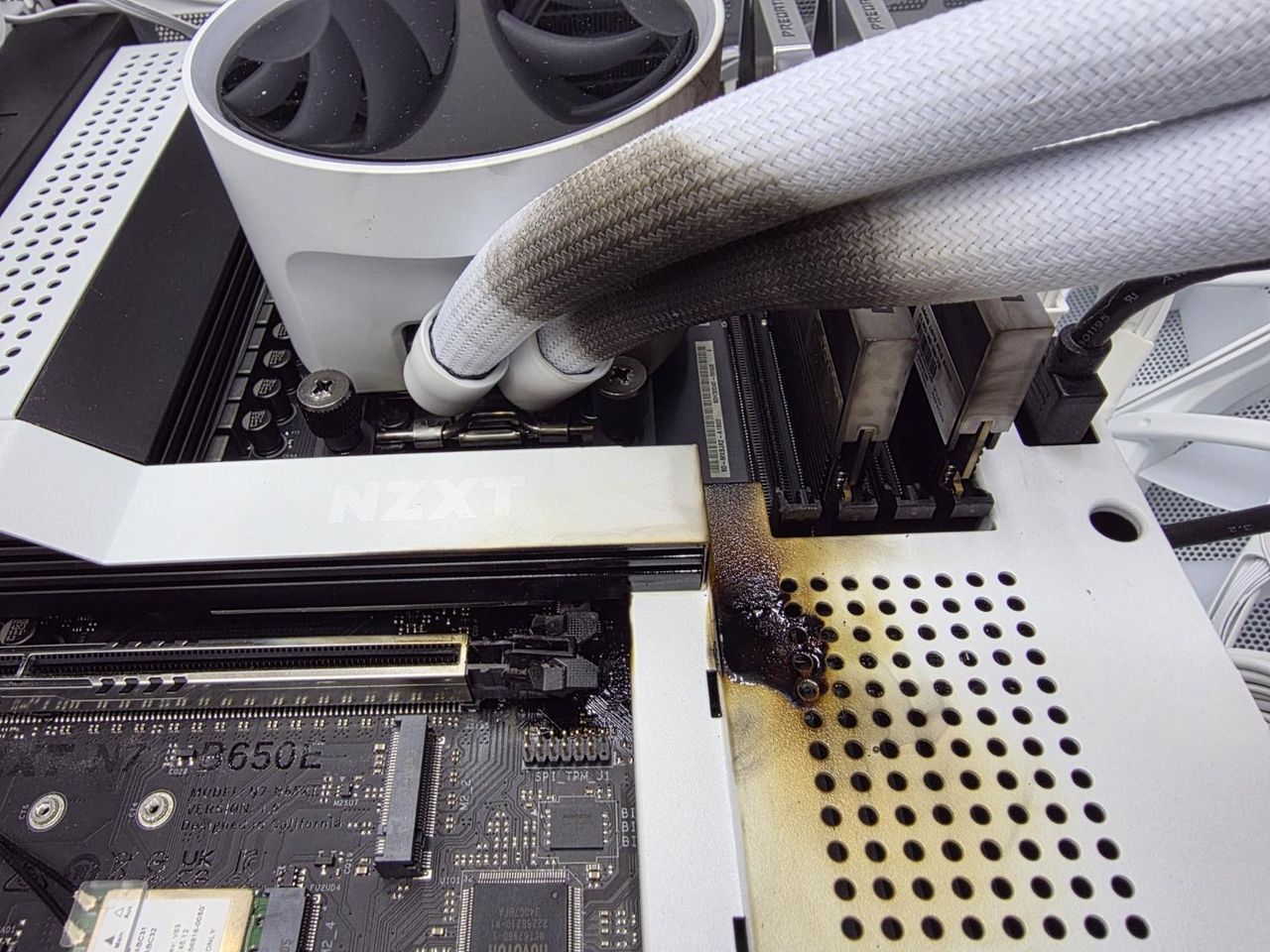 An RTX 5090 that caught fire and also left burnt marks on the motherboard, AIO cooler and RAM
