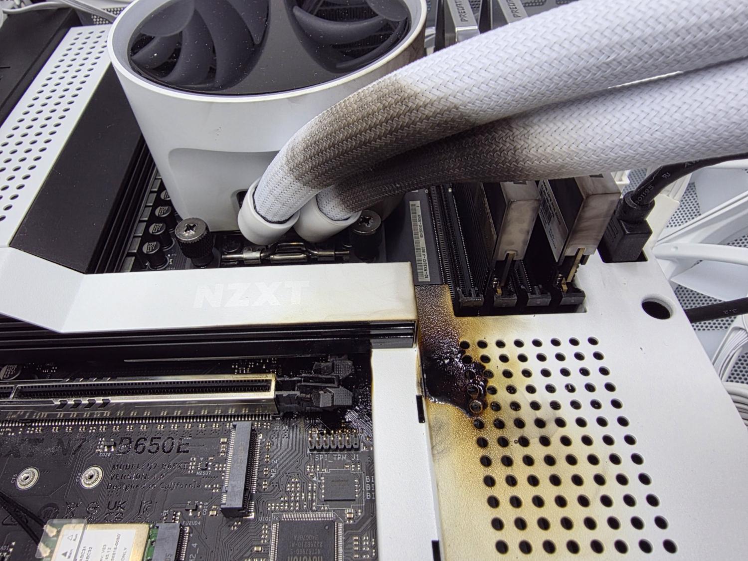 An RTX 5090 that caught fire and also left burnt marks on the motherboard, AIO cooler and RAM