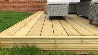 new decking installed next to a lawn