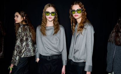 Female models dressed in the Giorgio Armani A/W 2014 backstage of the fashion show