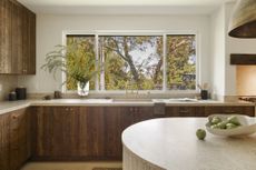 A kitchen with dark wood lower cabinets