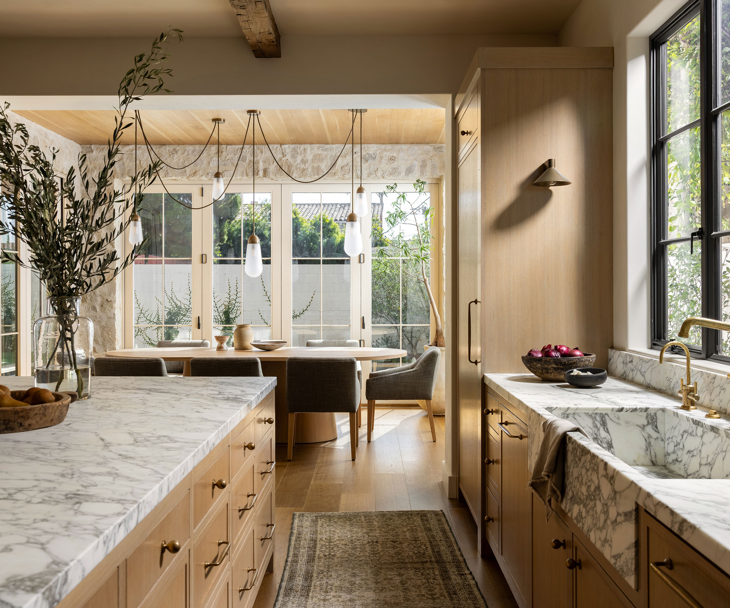 wooden kitchen with marble worktops and open plan dining area