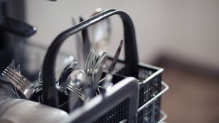 cutlery in a dishwasher facing up