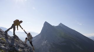 mountaineer giving a helping hand