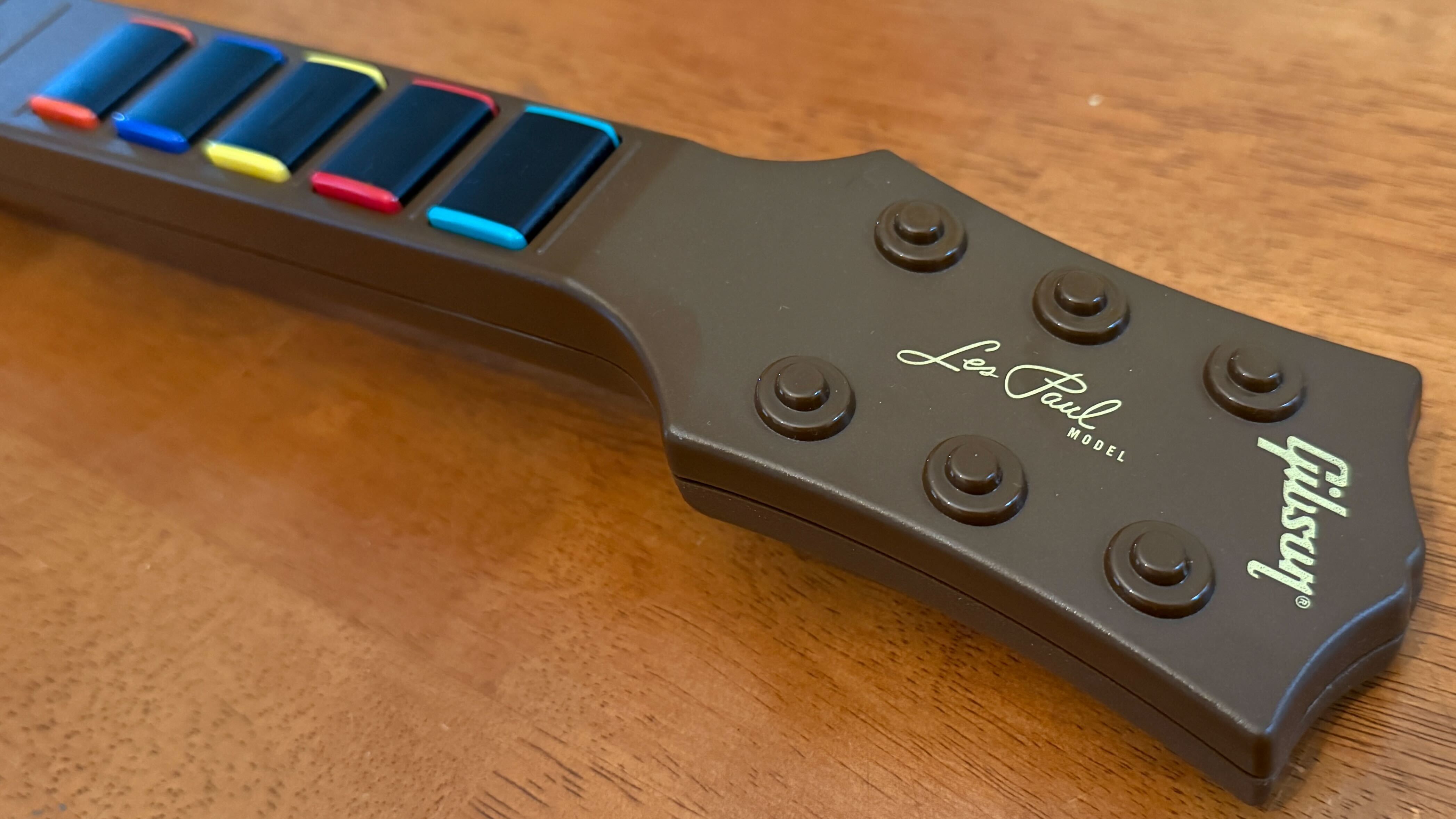 A close up of the Les Paul branding on the CRKD Guitar controller