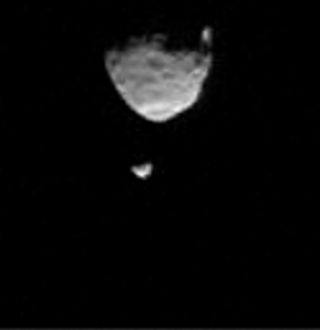 The moons of Mars, Phobos (top) and Deimos, are seen together in this image taken from the Martian surface by NASA's Curiosity rover on Aug. 1, 2013. A new study suggests Mars' largest moon Phobos may undergo a cycle of breaking into rings, then reforming