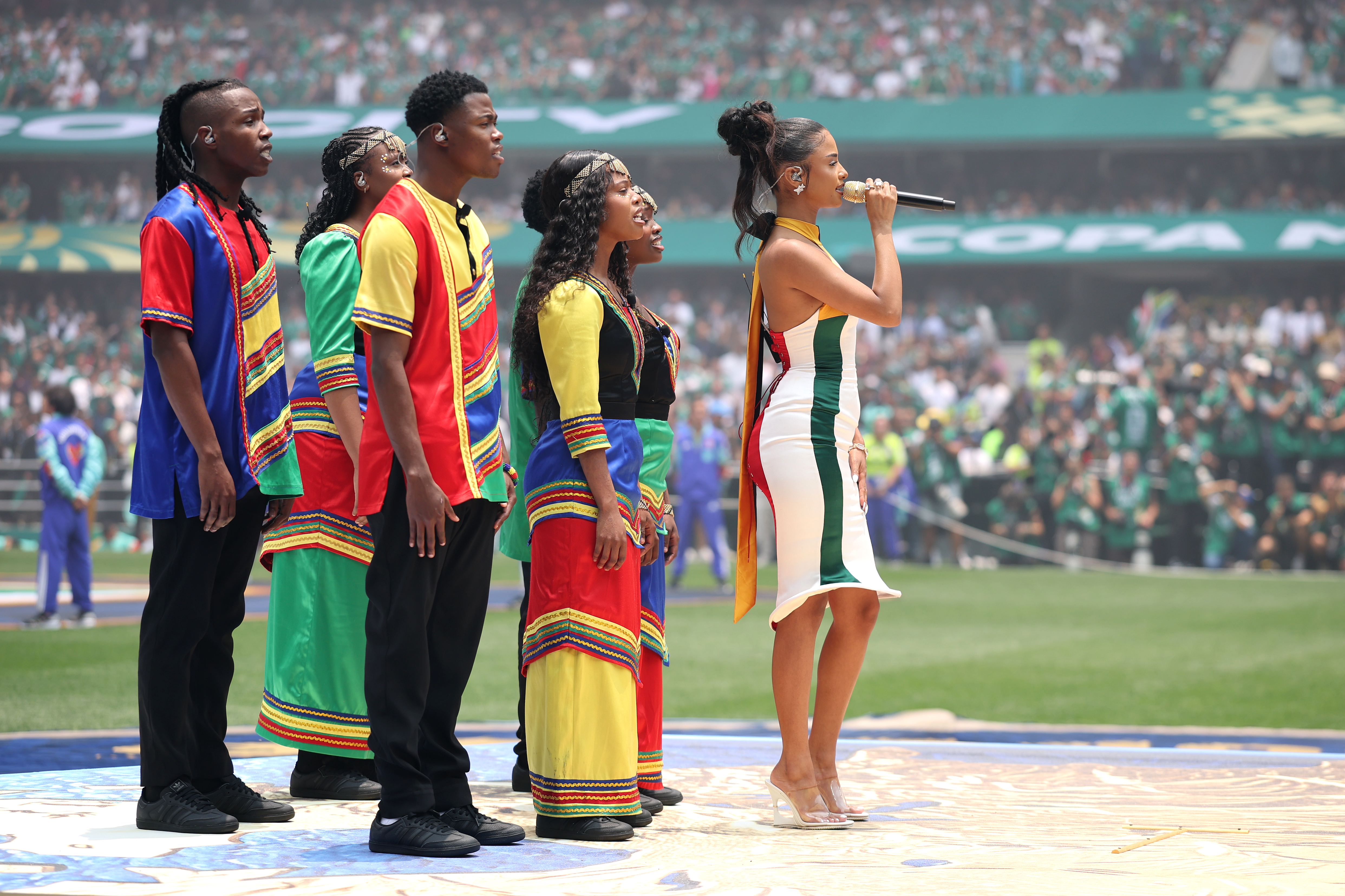 Tyla launches the World Cup in two custom outfits, including a dress inspired by the South African flag
