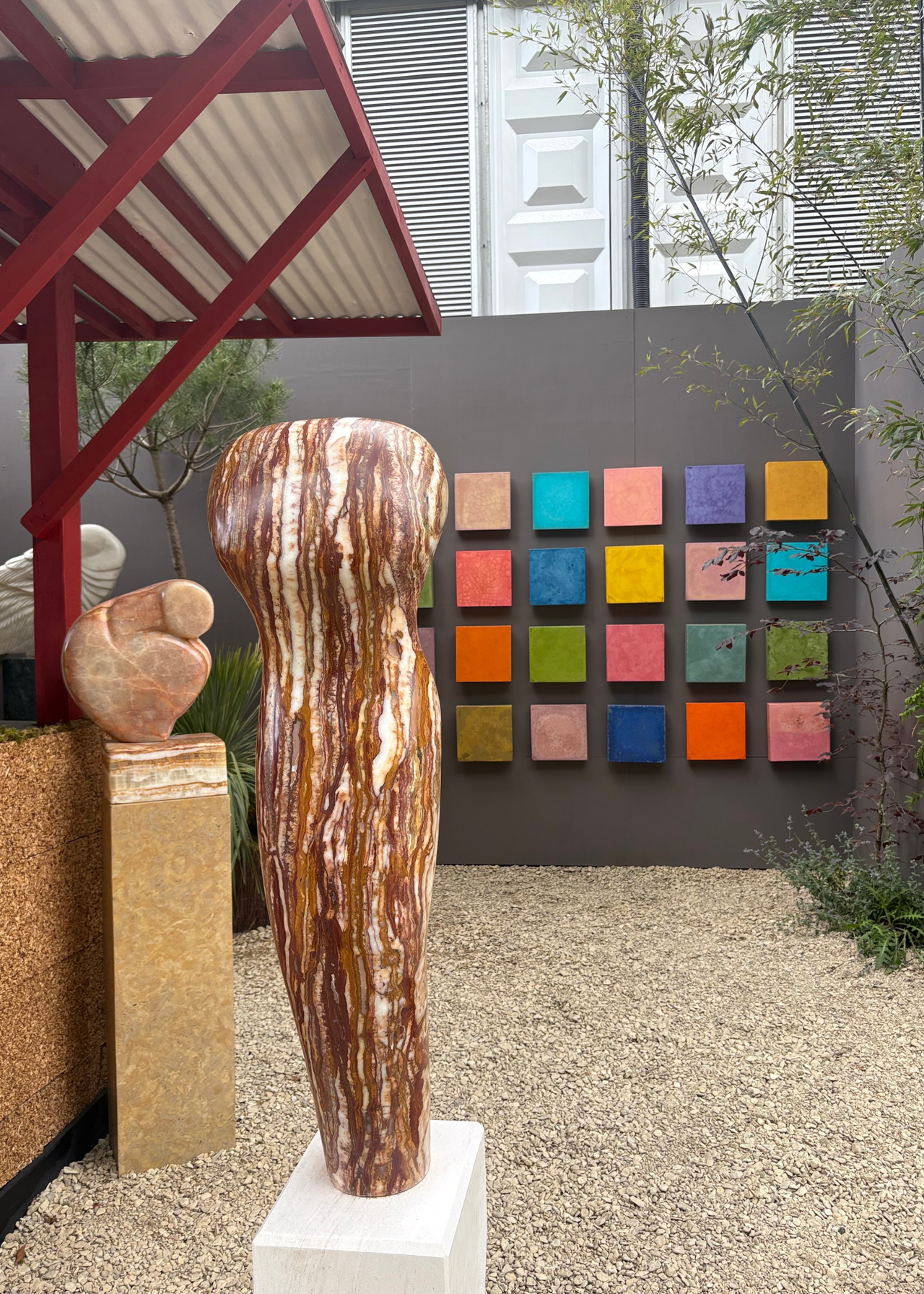 A sculpture and a wall of colorful ceramic tiles by Paul Vanstone and Dr Muirne Kate Dineen at the Chelsea Flower Show 2026