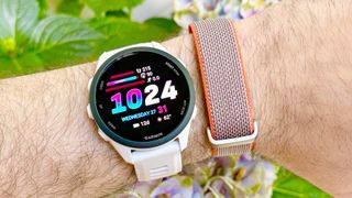 Close-up of the Garmin Forerunner 70 next to the Fitbit Air fitness tracker on the same wrist
