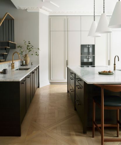 kitchen in period property with pale coloured cabinets and dark wood island with marble stone counter top