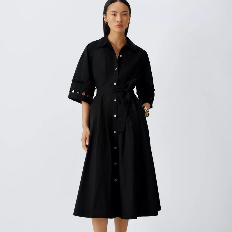 A woman wears a black dress from AND-OR