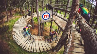 Riders on the North Shore trail in Bikepark Mottolino in Italy