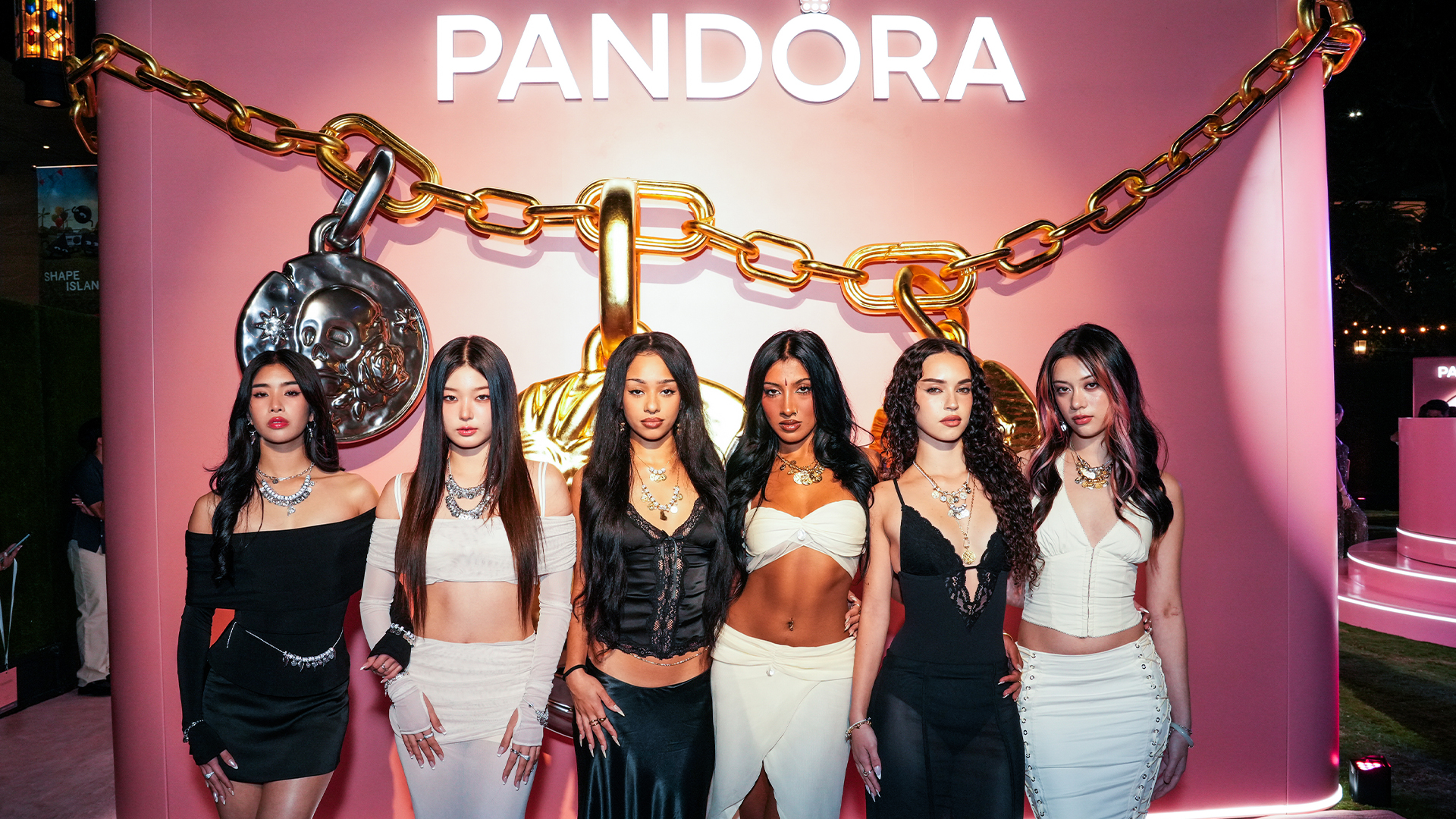 katseye poses in front of pandora sign