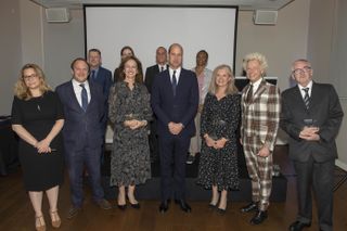 Prince William, Duke of Cambridge, Royal Patron of The Passage, poses with award winners as he marks the 40th anniversary of the The Passage
