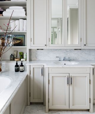 An example of bathroom storage ideas showing a fitted storage unit with a marble surface