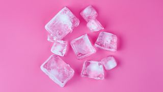 Directly Above Shot Of Ice Cubes Over Pink Background - stock photo