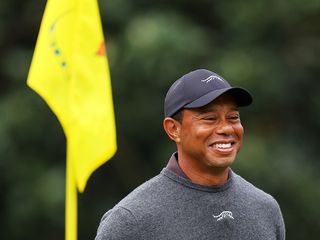 Tiger Woods in front of a pin flag at The Masters