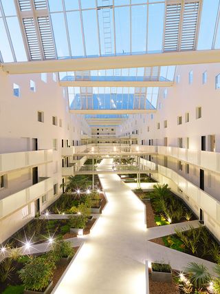 The atrium may act as open space for the residents, but it also helps with natural ventilation for the complex
