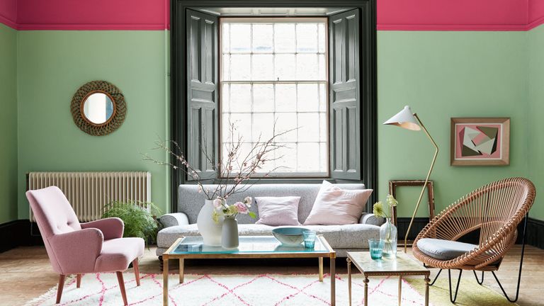 与桃红色和绿色墙壁和镶边地毯的抽象客厅