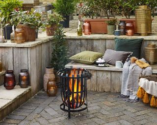 autumn winter cozy patio with fire pit and cushions from dobbies