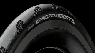 A black Continental Grand Prix 5000 TT TR tyre mounted to a black carbon rim