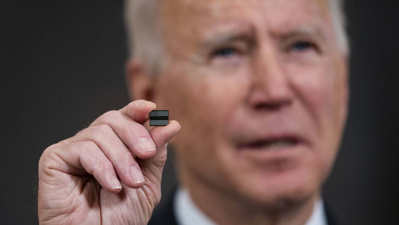 Joe Biden holds up a microchip at the White House in February 2021