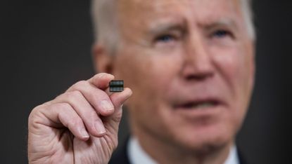 Joe Biden holds up a microchip at the White House in February 2021