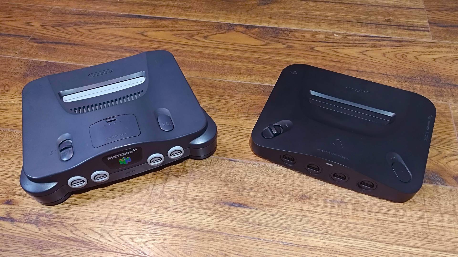 Analogue 3D on right and N64 on left on woodgrain surface.