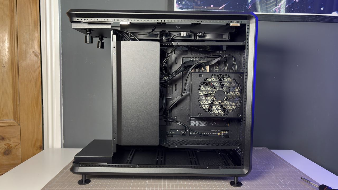The CoolerMaster MasterFrame 360 Panoramic PC case with various components installed on a desk.