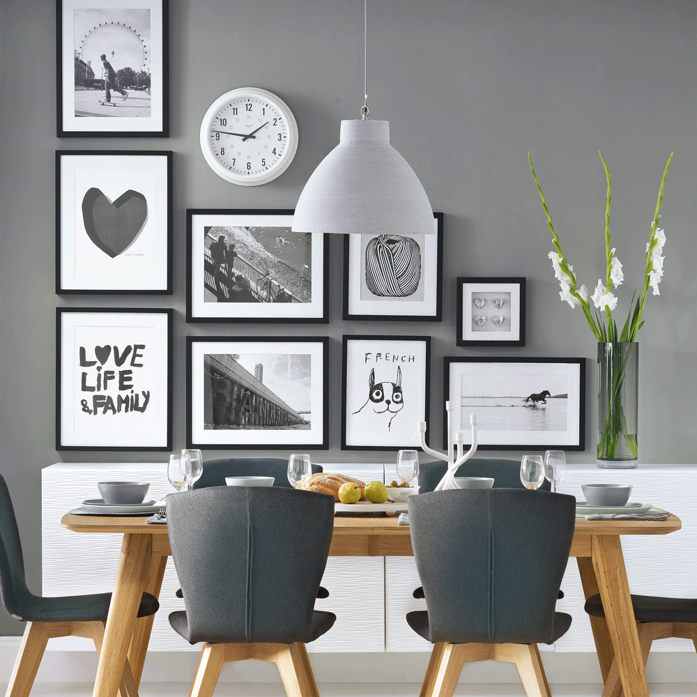 Feature wall with various sized black and white frames