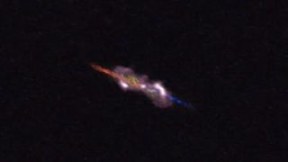 a fuzzy purple, blue and orange shape with two distinct jets.