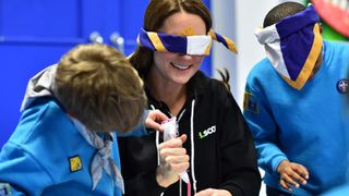 Kate Middleton playing with children, wearing a blindfold
