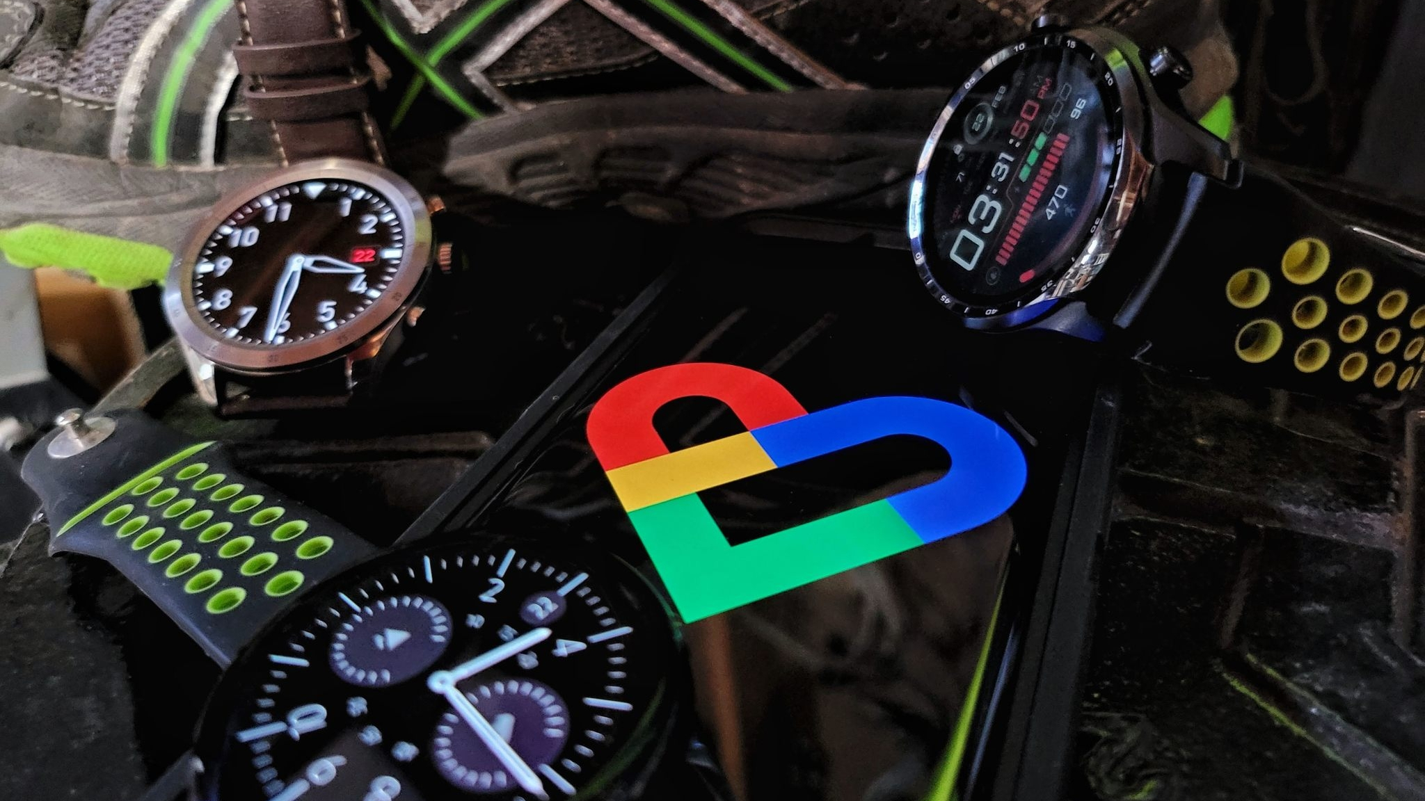 Smartwatches around a smartphone with the Google Fit logo