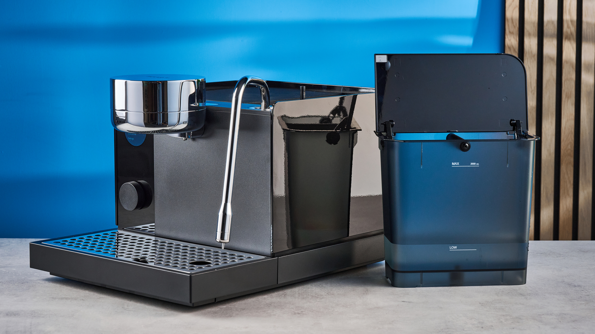 the fellow espresso series 1 photographed against a blue tom's guide background showing espresso, LCD smart screen, steam wand