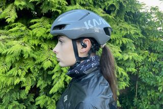Female cyclist wearing the Shokz OpenFit headphones