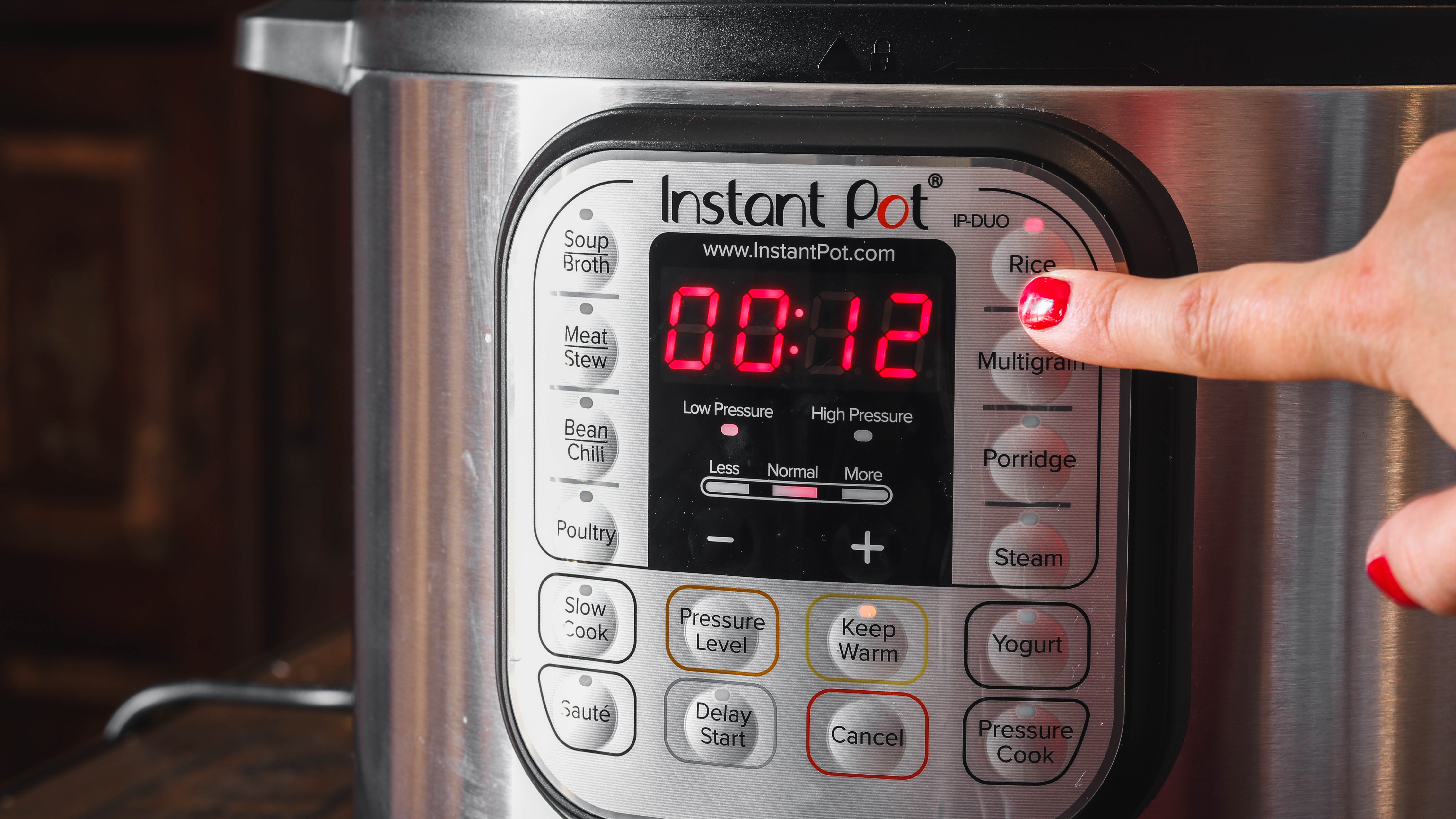 Woman setting program on Instant Pot control panel