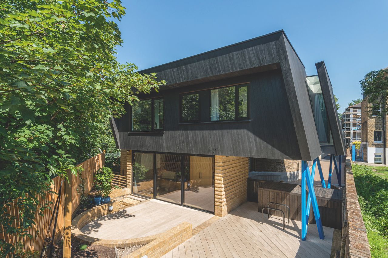 timber clad self build with blue steel supports