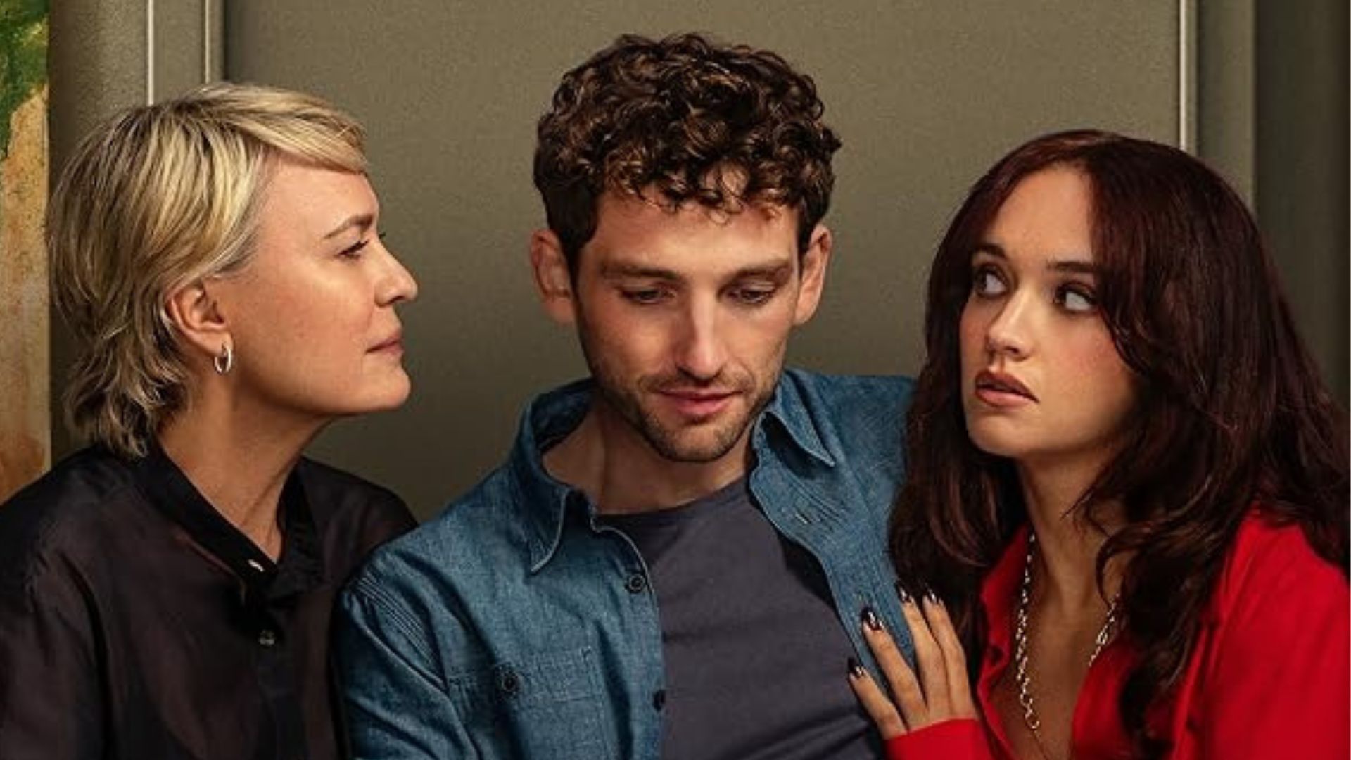 Robin Wright and Olivia Cookie look at Laurie Davidson on either side of him