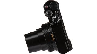 Panasonic Lumix TZ200 angled top view with lens extended on white background