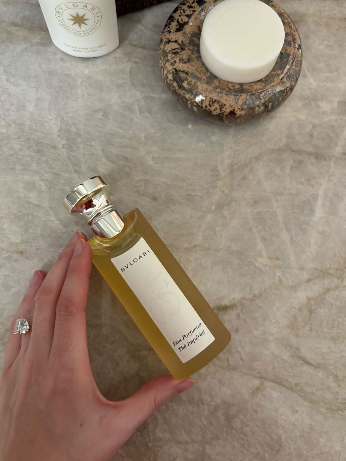 Deputy beauty editor Grace Lindsay holding a Bvlgari perfume