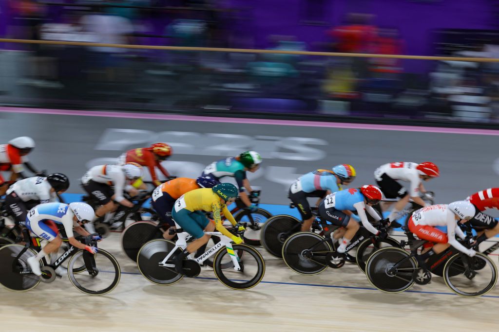 Riders compete in the women's track cycling omnium scratch race of the Paris 2024 Olympic Games at the Saint-Quentin-en-Yvelines National Velodrome in Montigny-le-Bretonneux, south-west of Paris, on August 11, 2024. (Photo by Thomas SAMSON / AFP)
