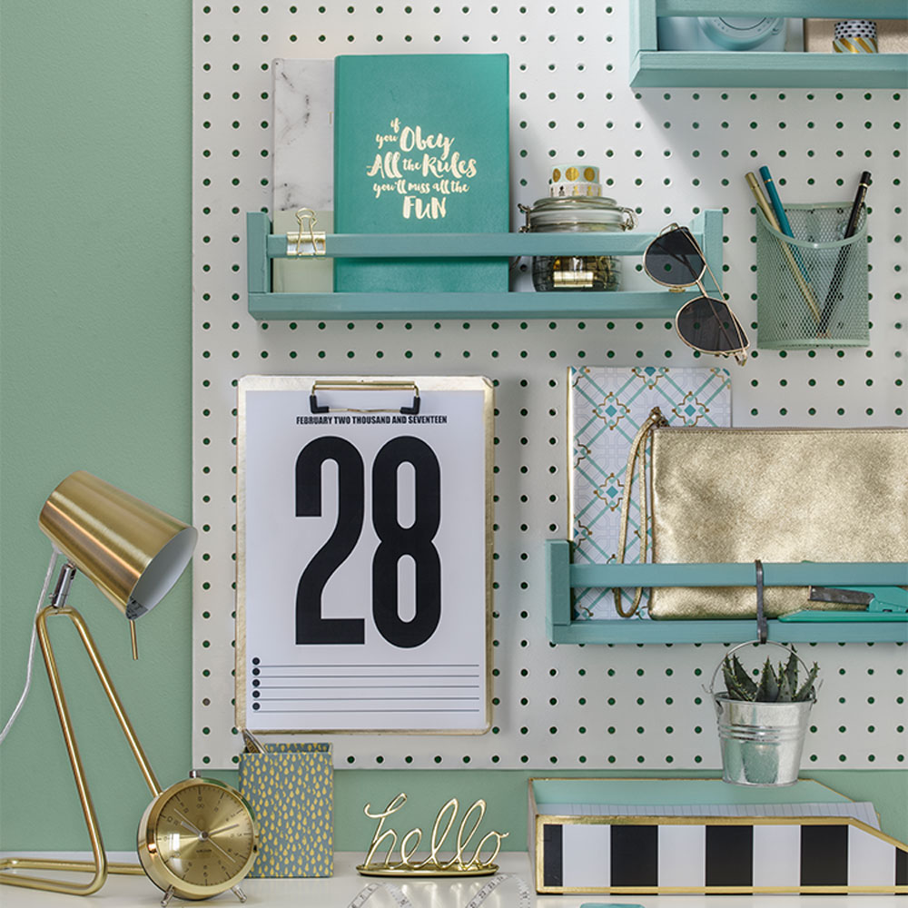 walled pegboard with lamp and purse