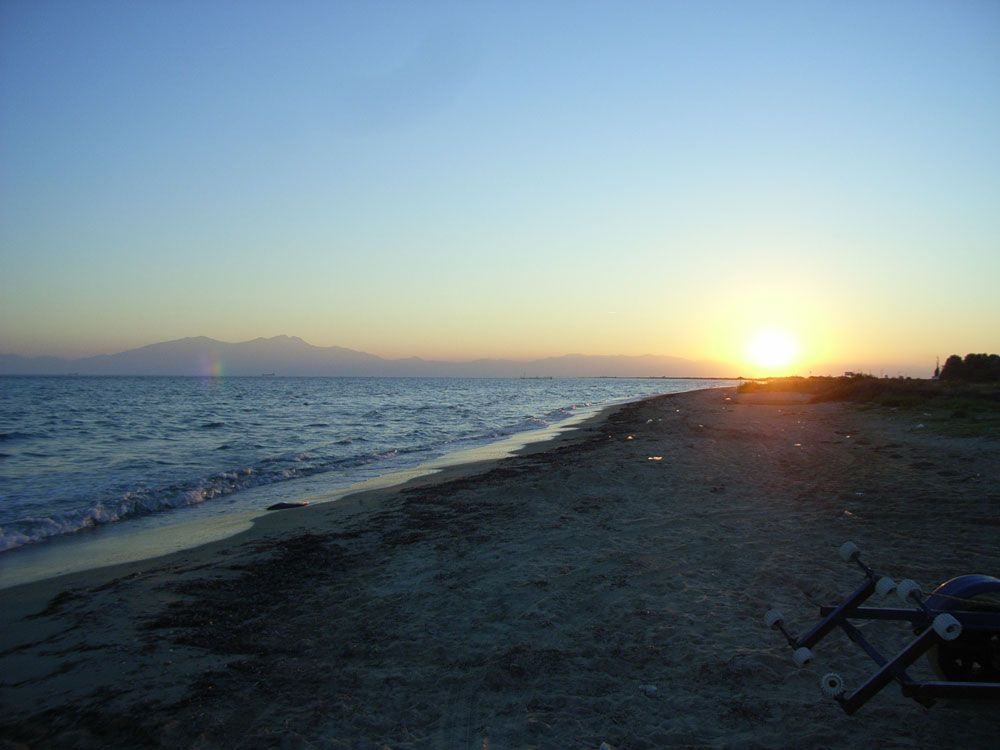 The sun sets over the Greek peninsula of Kassandra, where scientists conducted fieldwork. Mount Olympus looms in the distance.